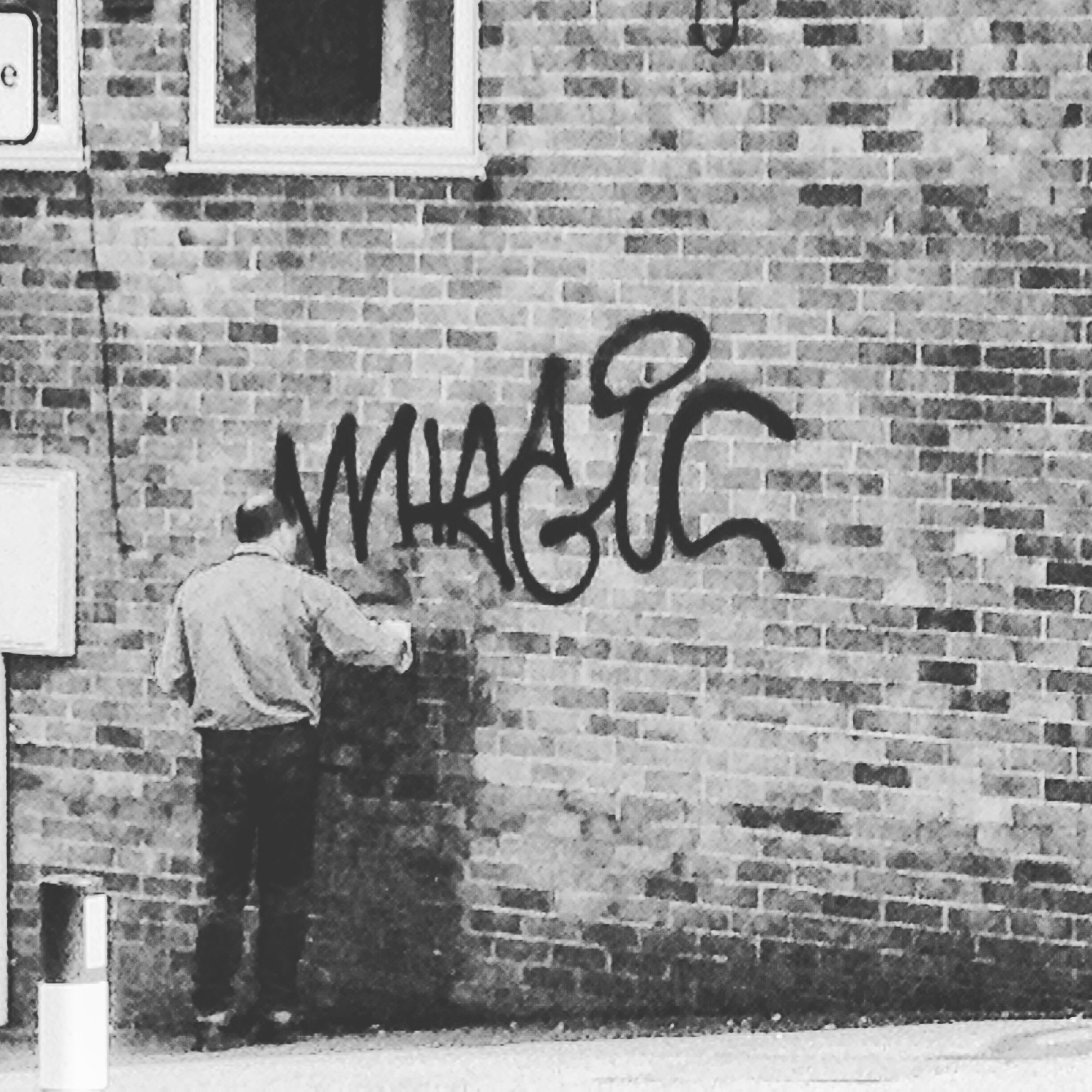 Man cleans graffiti done by Magic